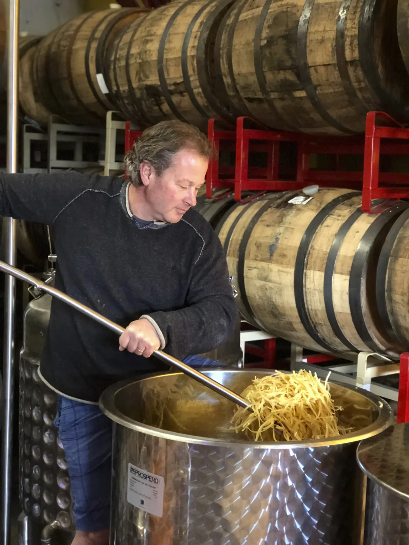 Fred Groth stirring fresh lemon peels at the distillery